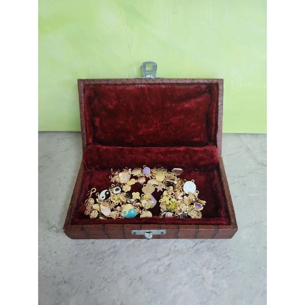 Faux alligator velvet lined box filled with charms